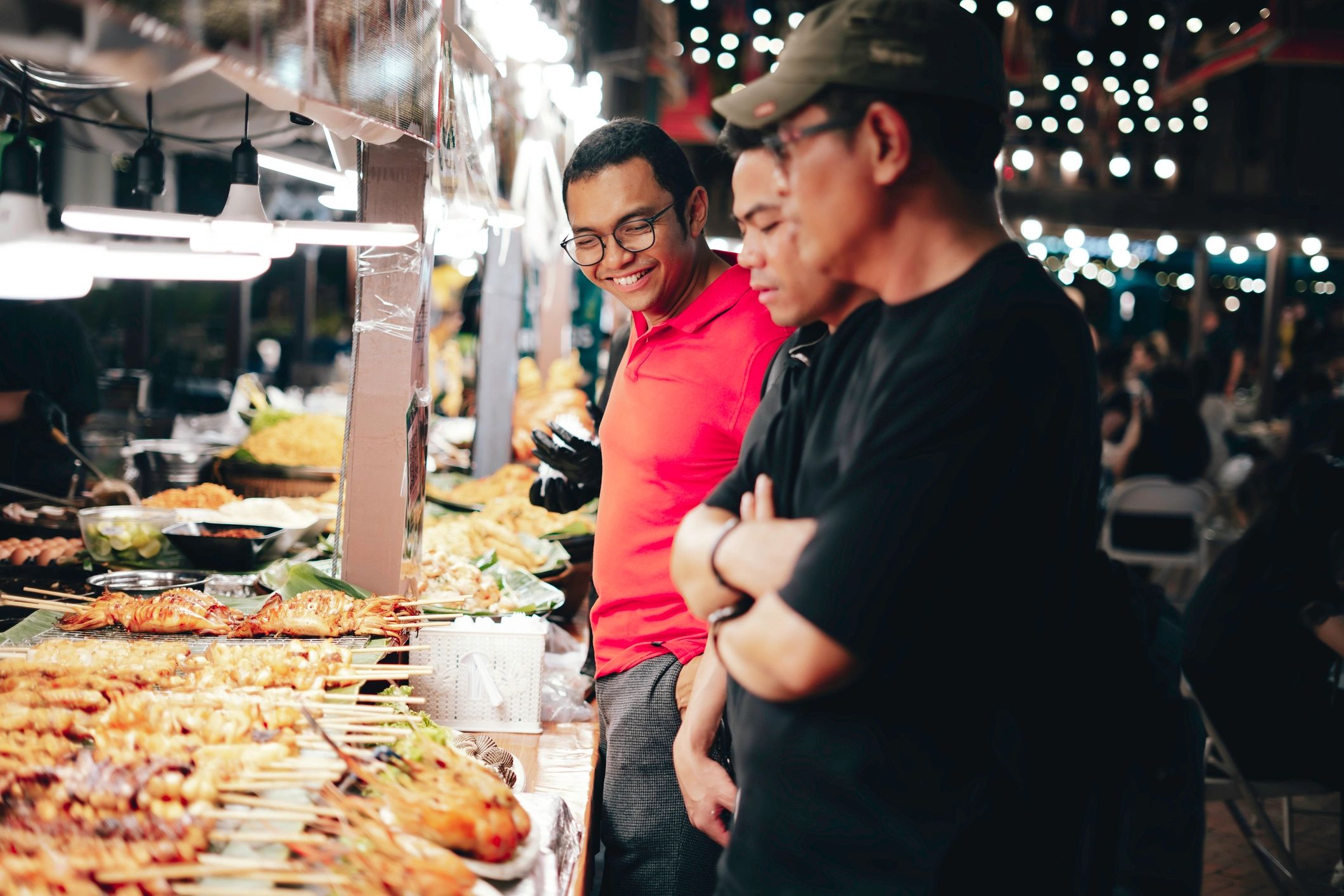 Customer buying barbecue street food from a vendor